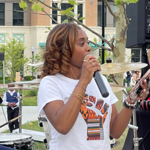 Adult speaking to attendees at Juneteenth Event